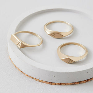 A collection of personalised engraved rings in solid 9ct gold, featuring oval, rectangle, and kite-shaped signet rings. Thoughtful gifts for special occasions.